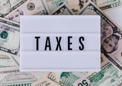 Sign that says taxes laying on money
